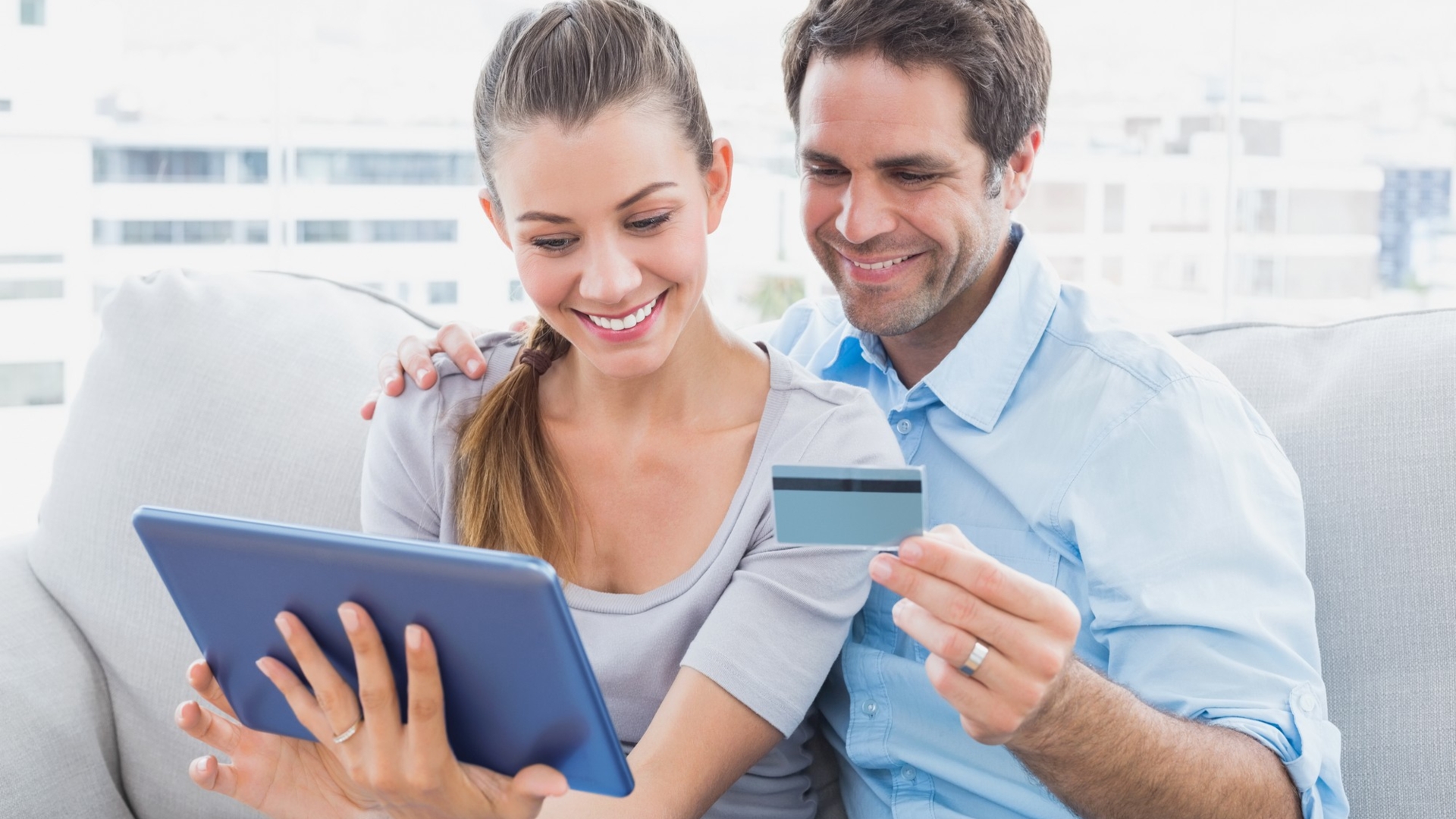 couple_smiling_happy_laptop_tablet_online_shopping_bank card_holiday_gift_millenials_image_123_27159059_xxl