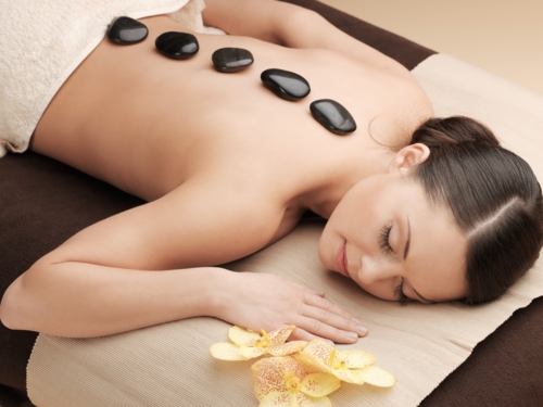 wellness_massage_lava_stone_brunette_flower_relax_image_sh_191337509